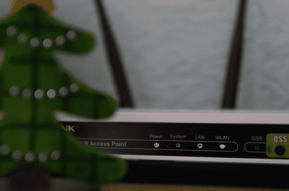 white and black modem router with four lights