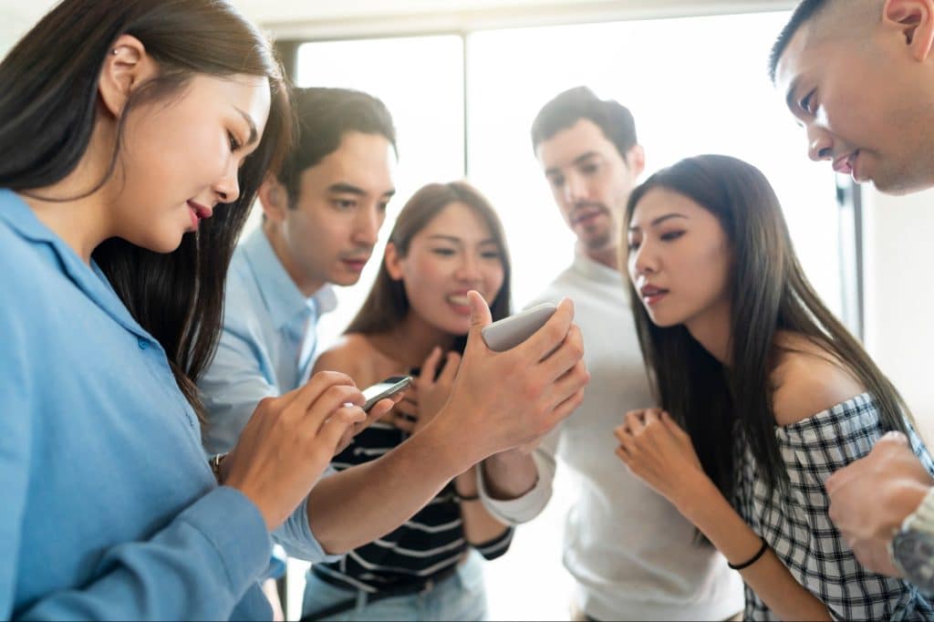 Group of friends staring at the phone