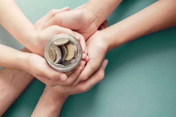 Child and Parents Holding Money Jar