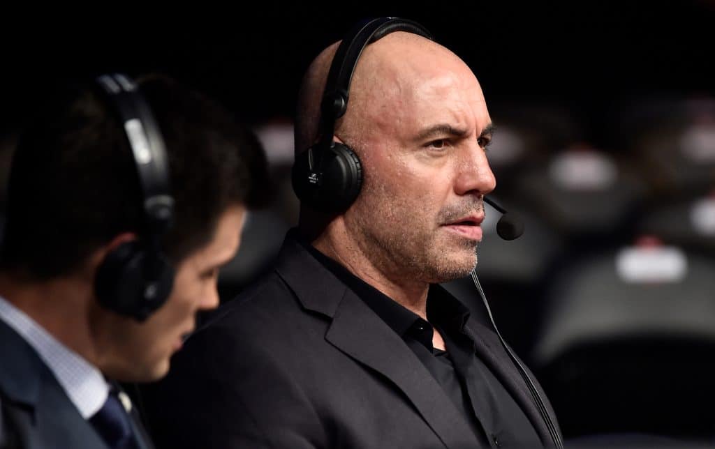 Joe Rogan is seen in the commentary booth during the UFC 220 