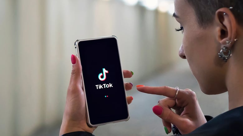 Girl Holding Phone With TikTok