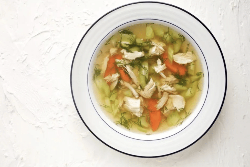 Bowl of traditional Israeli chicken soup with carrots