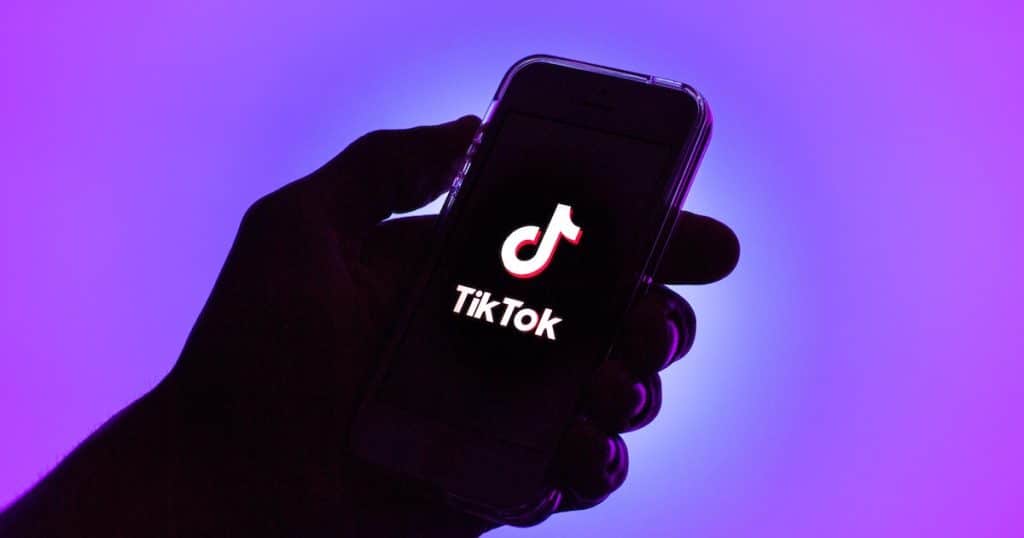 Holding Phone With TikTok