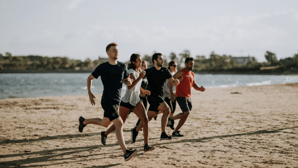 Group running on the beach after recovering from total knee replacement