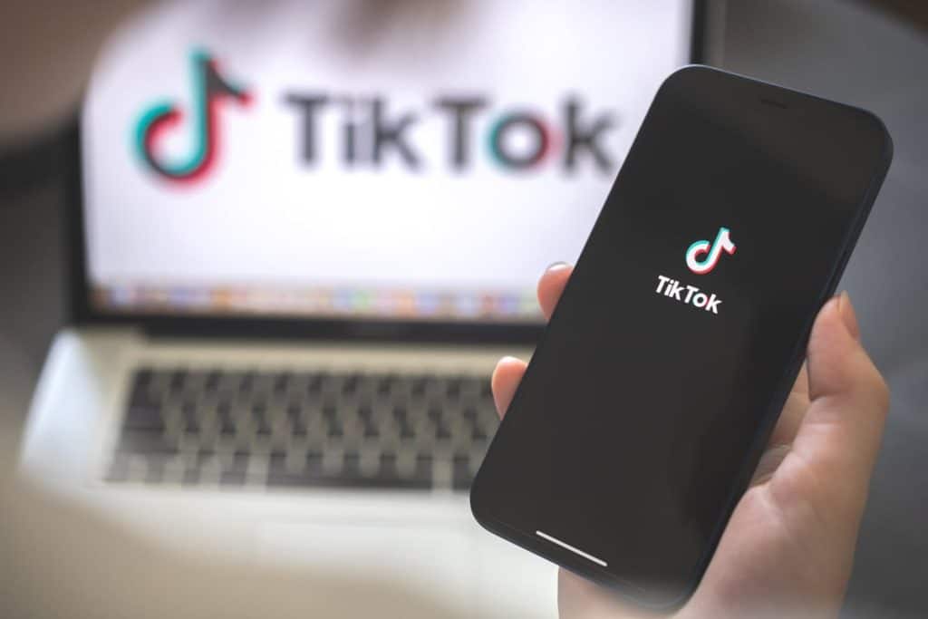 A person holding phone with Tiktok on screen.