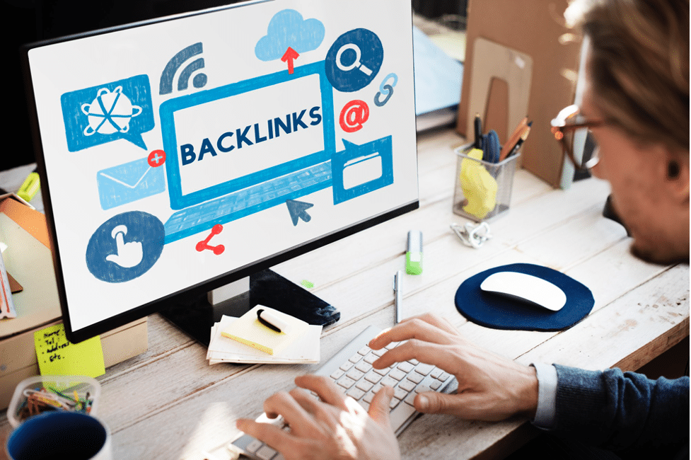 A person working at a computer with a backlinks concept on the screen