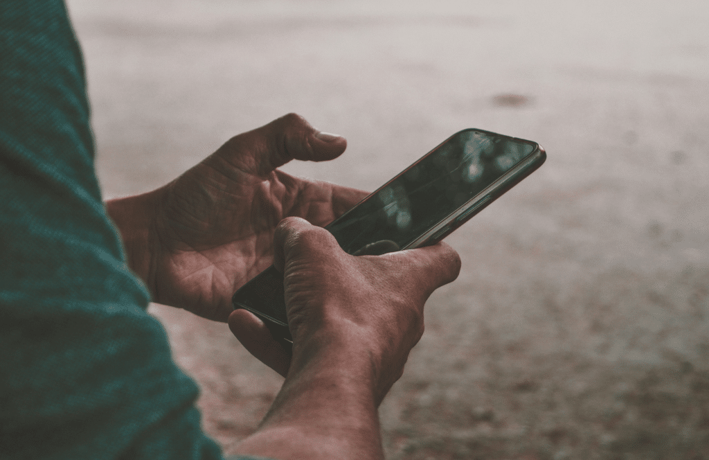 Smartphone displaying postpaid plan benefits, representing connectivity for digital lifestyles