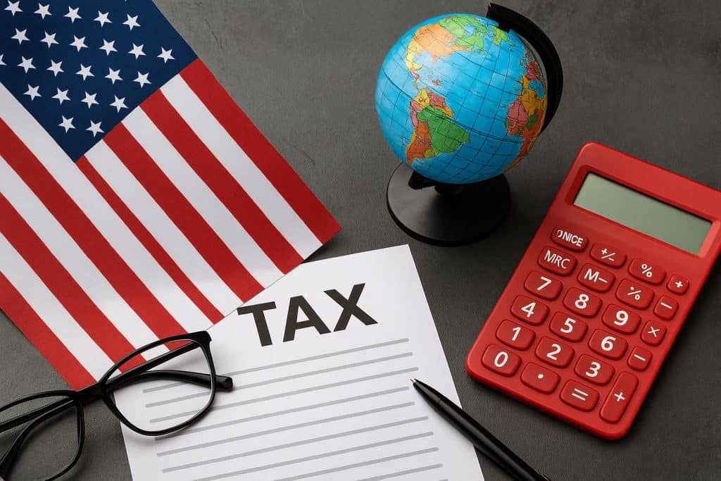 U.S. passport, tax forms, and globe representing expat tax compliance and global financial strategy