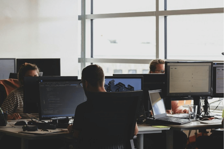 people sitting on chair in front of computer monitor