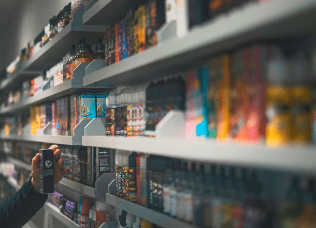 Woman in black shirt browsing products on supermarket shelf
